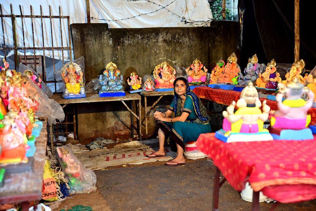 A woman and child among the colourfully decorated Ganesh idol stalls in Gulbai Tekra, Ahmedabad
