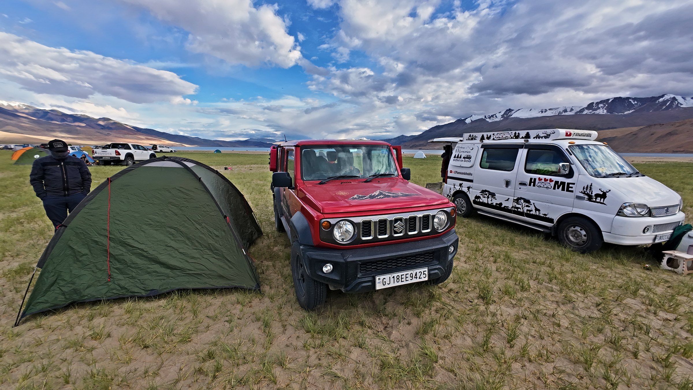 Pannu and Shubhu's van HOME parked beside a red Suzuki Jimny and a tent at Tso Moriri, Ladakh