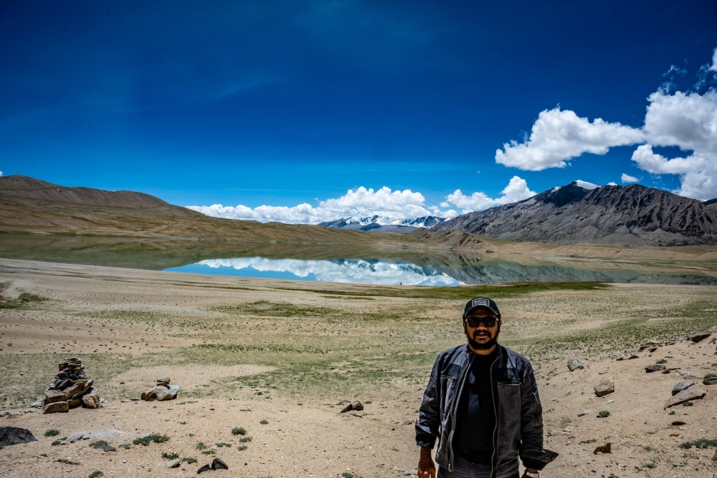 Alok Brahmbhatt beside a Himalayan lake in Ladakh
